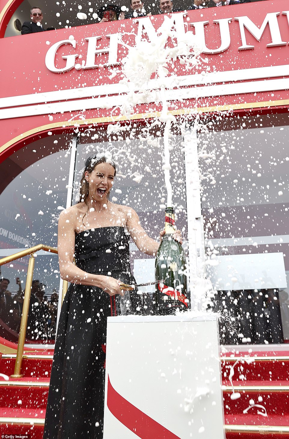 Emma McKeon, 30, (pictured) made a splash as she ruined her $10,000 Dior gown when she popped a bottle of Champagne