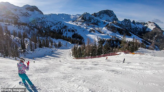 A snowboarder hits the slopes in Nassfeld, Austria