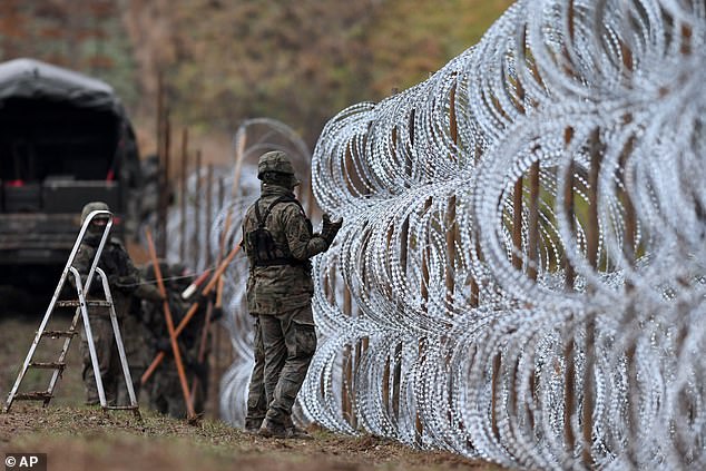 Polish soldiers begin laying a razor wire barrier along Poland's border with the Russian exclave of Kaliningrad in November 2022