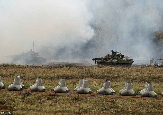 Polish soldiers operate amoured tanks during the military exercise 'Shield East' defence programme in the Land Forces Training ground in Orzysz, northern Poland, October 14