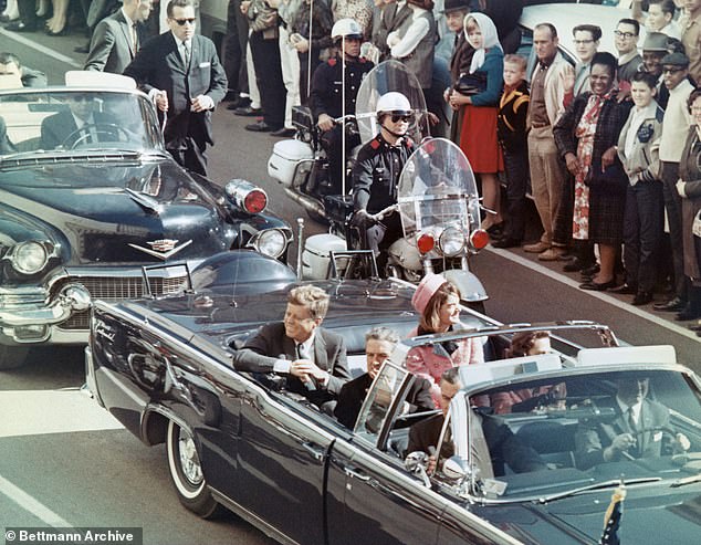 US President John F Kennedy, First Lady Jacqueline Kennedy, Texas Governor John Connally, and others smile at the crowds lining their motorcade route in Dallas, Texas, on November 22, 1963. Minutes later the President was assassinated as his car passed through Dealey Plaza