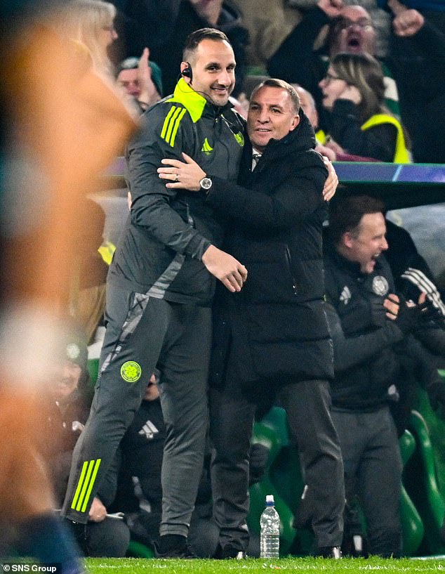 Brendan Rodgers stretches to give assistant John Kennedy a hug after their victory