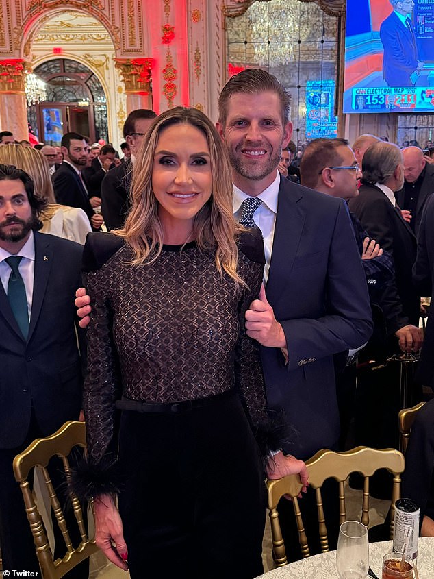 Lara and Eric Trump pose for a photo as Donald Trump declares victory in the US elections