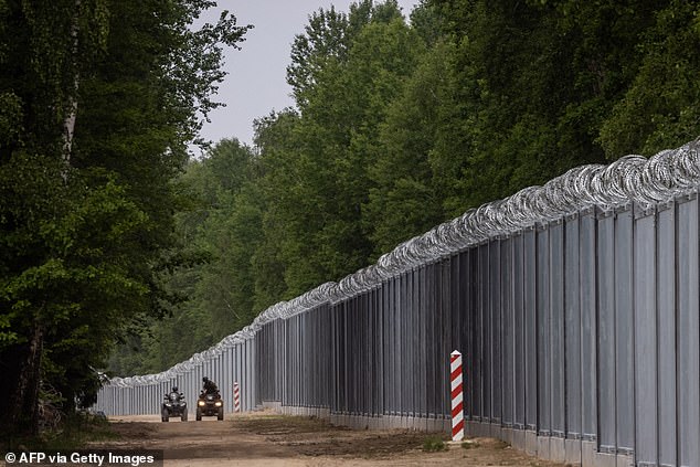 Border guards patrol on quads along the border wall at the Polish-Belarusian border near Tolcze village in north-eastern Poland on June 8, 2022