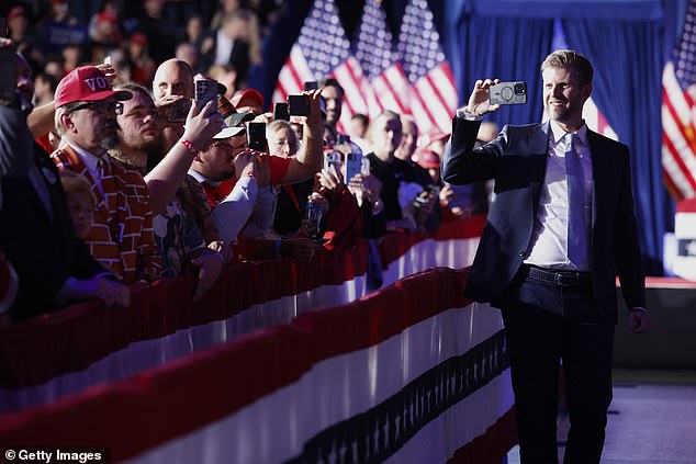 Eric Trump records video of supporters during a campaign rally at Van Andel Arena on November 5, 2024 in Grand Rapids, Michigan