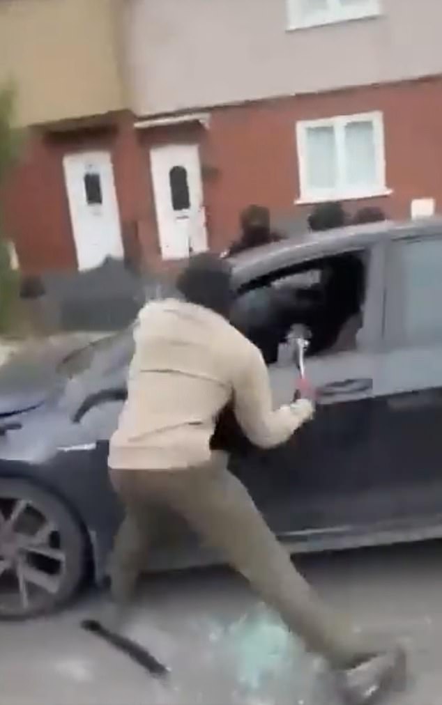 Thugs smashed the passenger window of the black Volkswagen Golf before running towards the driver and landing a string of blows on him