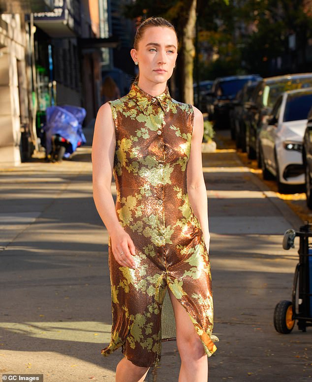 The collared dress shimmered in the light thanks to thousands of delicate brown and gold beads that were arranged to create lovely floral designs