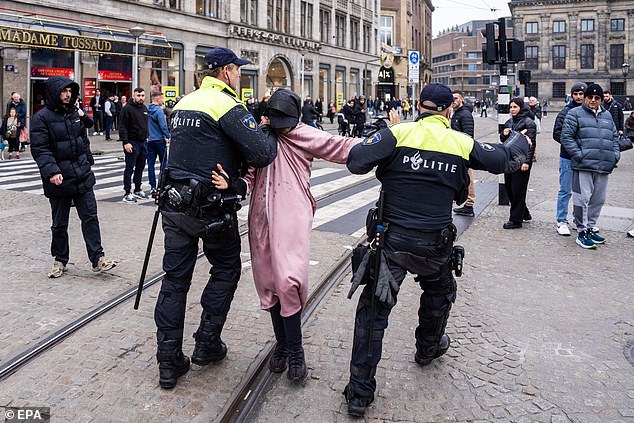 Dutch police detain a man at De Dam in Amsterdam after allegedly provoking Maccabi Tel Aviv supporters ahead of the match yesterday