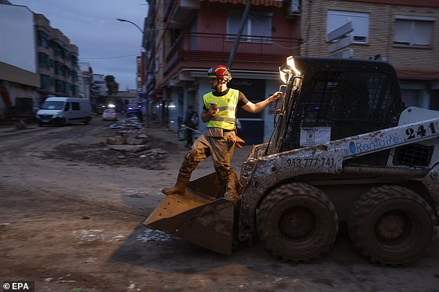 A firefighter helps in the cleaning of the flood-hit municipality of Paiporta, province of Valencia, Spain, 12 November 2024