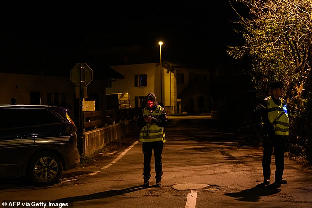 French gendarmes stand guard at the entrance of a street, near the location where three children were found dead, in Taninges, eastern France, on November 12, 2024