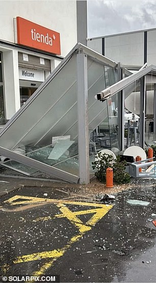 A shelter is seen destroyed after high winds hit a petrol station near Spain