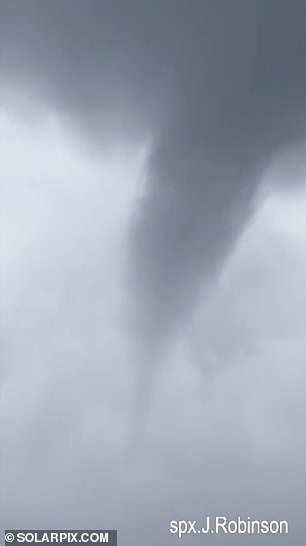 A waterspout is seen out to sea