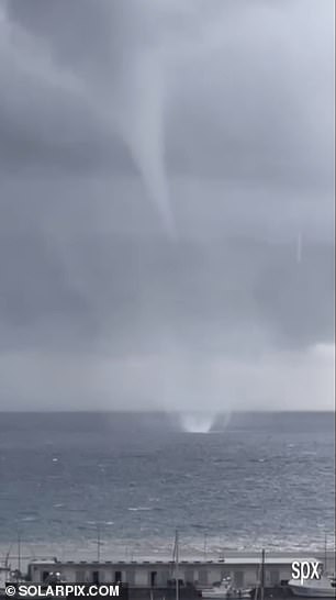 A waterspout is seen out to sea