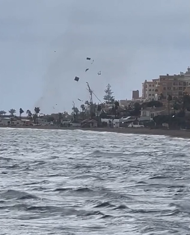 Debris was seen flying over buildings as a mini-tornado hit the coastline in Marbella