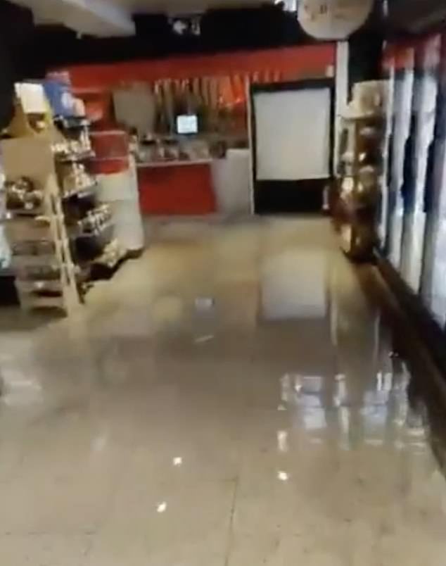 Supermarket floors are steeped in water in Malaga, where people have been urged to stay at home