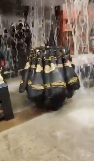 Water is seen gushing down from the ceiling in a shopping centre