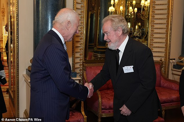 The King was all smiles as he greeted Ridley Scott at the reception, which took place at Buckingham Palace