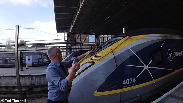 The first job for driver Dom at St Pancras is to wash the windscreen