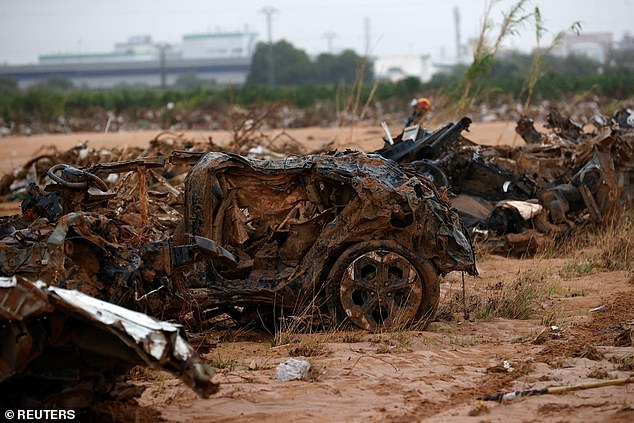 Cars destroyed by the impact of rains are pictured in the Barranco del Poyo in Quart de Poblet, Valencia