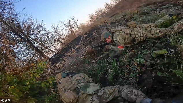 In this image taken from a video released by the Russian Defense Ministry on Thursday, Nov. 7, 2024, Russian Army soldiers fight with Ukrainian Armed forces in the Sudzhansky district of the Kursk region of Russia