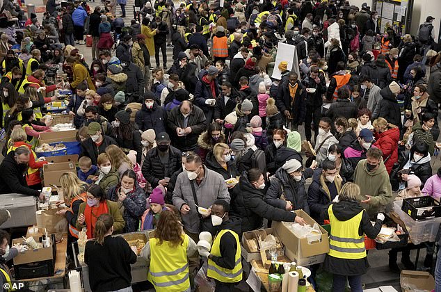 Ukrainian refugees queue for food in the welcome area after their arrival at the main train station in Berlin, Germany, March 8, 2022