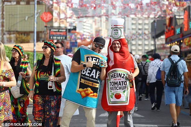 Attendees dress as a tin of Heinz beans and a ketchup bottle at the fancy dress parade