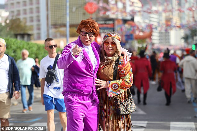 Two attendees in fancy dress costumes take to the streets of Benidorm