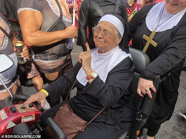 Two women dressed as nuns attend the parade in Benidorm on Thursday