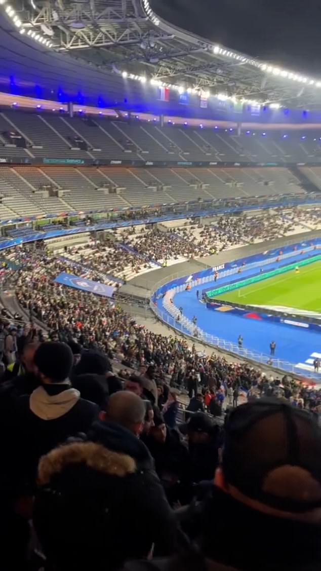 Mobile phone footage shows fans in the Stade de France fleeing their seats after a fight was reported to have taken place in the first half