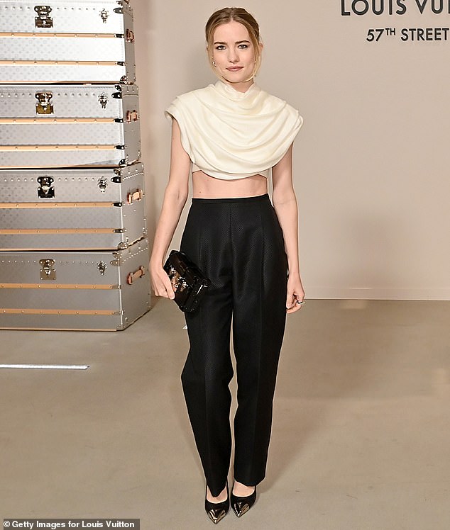 Willa Fitzgerald flashed her toned midriff in an off-white, draped cropped top and high-waisted black trousers