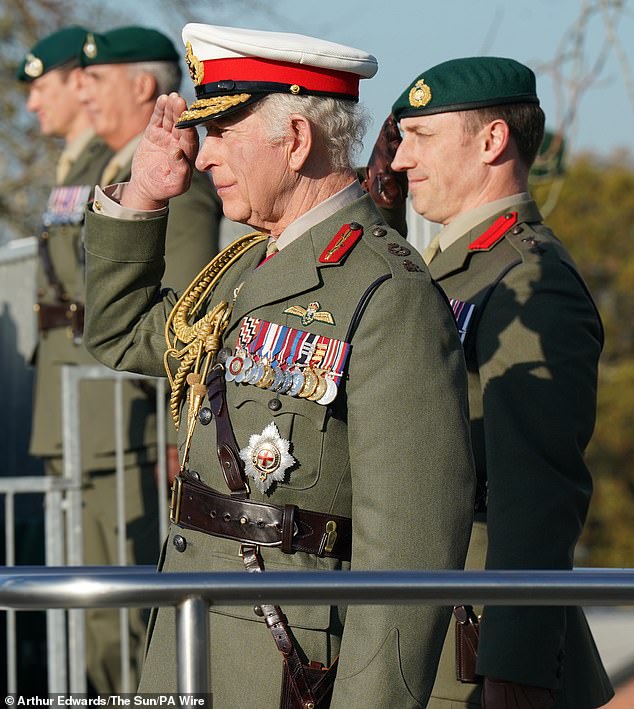 King Charles takes the salute during a visit to the Commando Training Centre Royal Marines