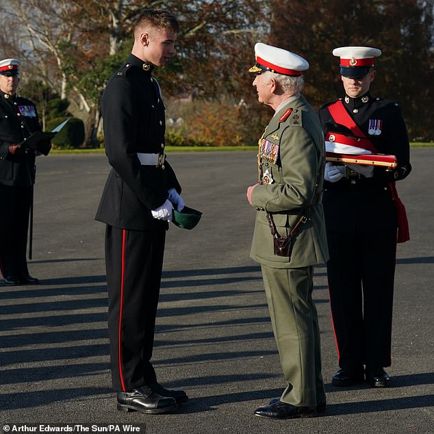 The King awards Marine Joseph Ryan, the Commando Medal during a visit to the Commando Training Centre Royal Marines