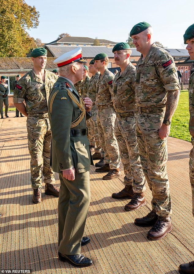 His Majesty was presented with a picture of himself tackling the high ropes at the training centre, while he watched recruits perform the same manoeuvre