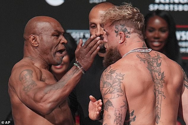 Tyson slaps Paul during their explosive weigh-in ahead of their bout on Saturday (AEST)