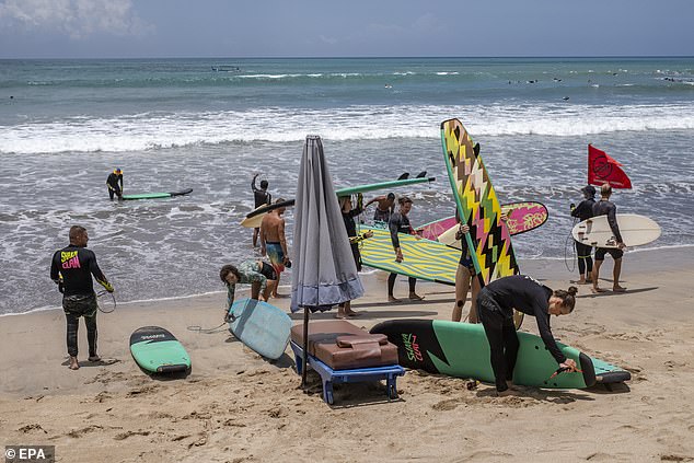 Indonesia blasphemy laws cover the country's major religions including Islam, Christianity, Hinduism and Buddhism and apply to comments made online (pictured, tourists in Kuta, Bali)