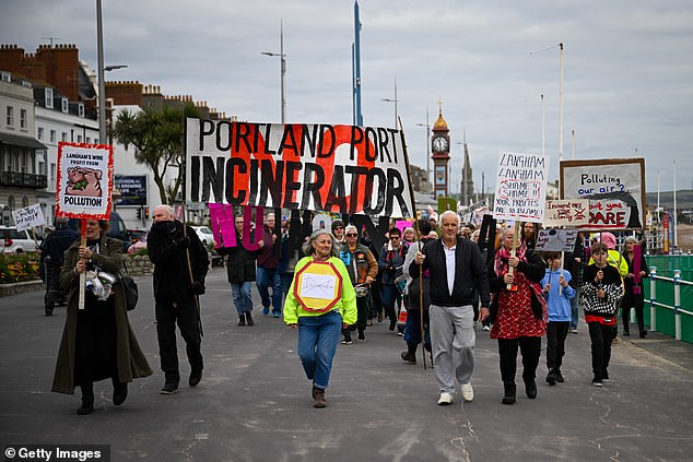 Campaigner Giovanna Lewis (centre) leads protestors on a march down Weymouth seafront