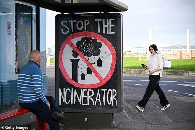 A sign on a bus shelter on Portland says 'Stop the Incinerator'