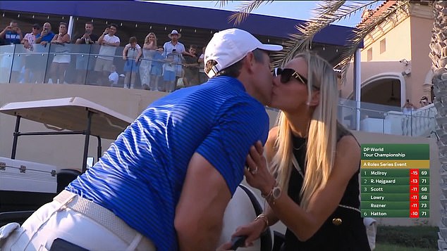 McIlroy and his wife Erica Stoll (right) shared a kiss after McIlroy clinched his sixth Race to Dubai title