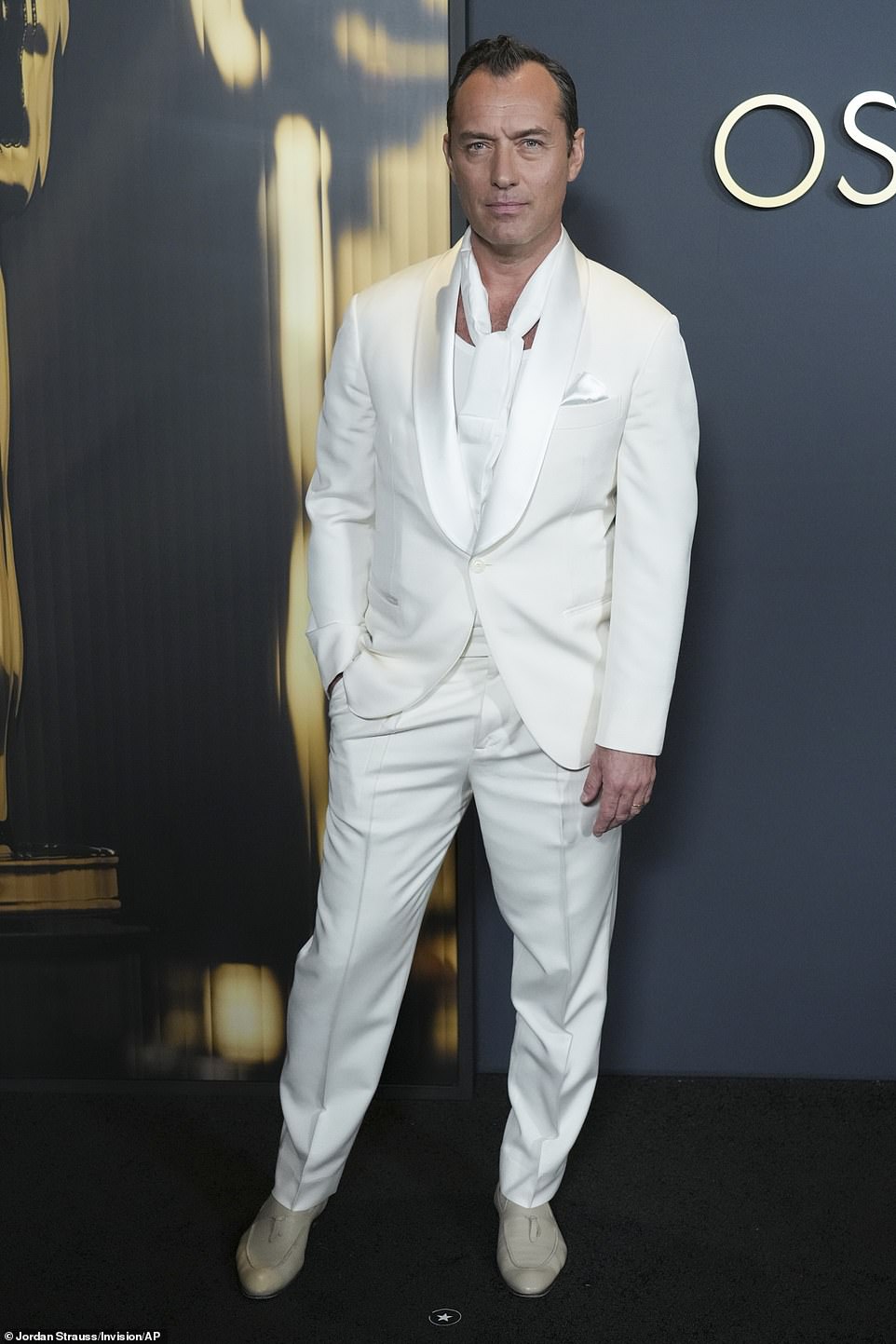 Jude Law, 51, cut a handsome figure in an all-white suit