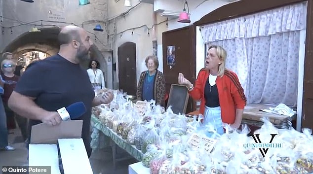 A woman emerged from the house behind the stall and came to the defense of her elderly relative