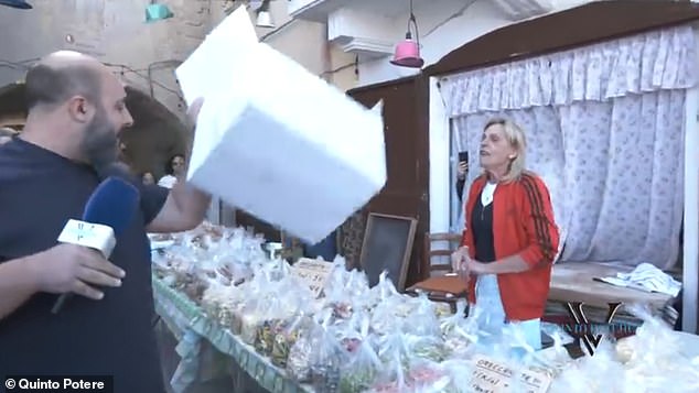 Loconte shakes a box at a pasta seller, claiming that her produce is mass-produced rather than homemade