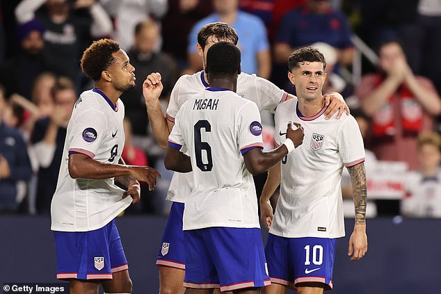 Pulisic is seen celebrating his second goal of the game with his USA teammates