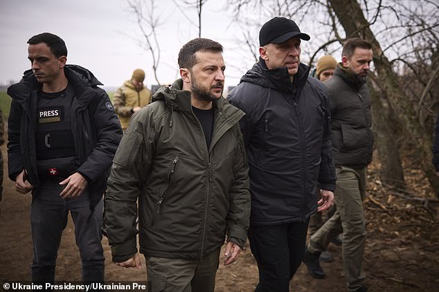 Ukrainian President Volodymyr Zelensky, left, walks with Vadym Fiashkin, head of the Donetsk Regional Military Administration, right, during a tour of frontline positions, November 18, 2024, in Kramatorsk, Donetsk Oblast