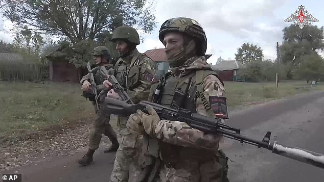 Russian soldiers patrol a village in the Russian - Ukrainian border area in the Kursk region