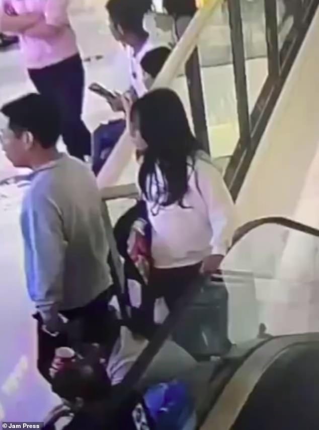 Horrifying CCTV footage from the incident shows the woman - who has not been named - leaning against the escalator before she tries to hois herself on up on the moving handrail