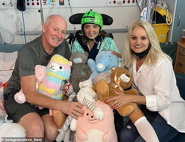 Leary (pictured with her parents Russ and Belinda) had to learn how to walk again after a horrific bike accident in 2021 came incredibly close to claiming her life