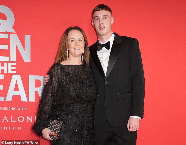 Palmer also posed for a photo with his mother Marie (left) at the swanky event in London