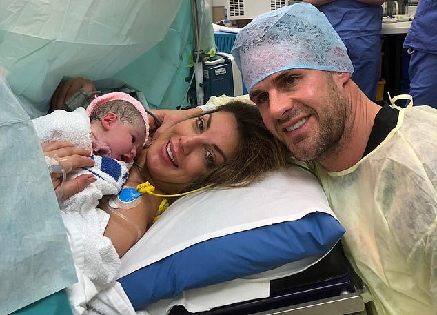 Lee and Andrea smile together after welcoming baby Jemima into the world in 2019