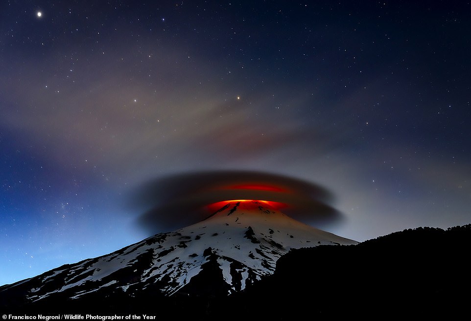 Chilean photographer Francisco Negroni captured this powerful image of the Vilarrica Volcano in Chile 'illuminated at nightfall'. The volcano last erupted in 2015. Negroni, who takes 'regular trips' there, says 'some nights are calm, others furious as in this photograph, where the brightness of the crater illuminates the night sky'