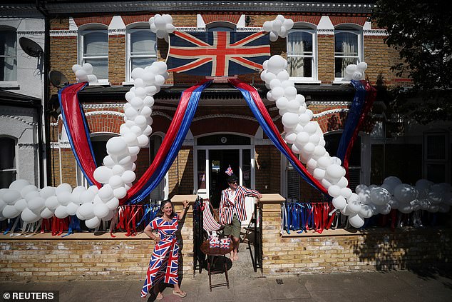 Pictured are Jane and Toby Lyde outside their house in Tooting on the 75th Anniversary of VE Day, London in 2020